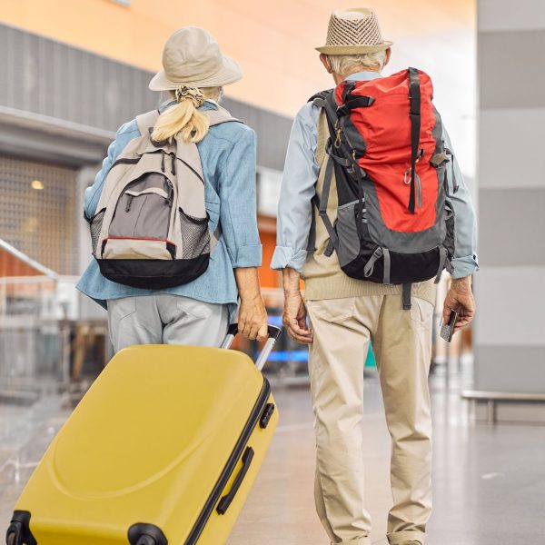 Two Caucasian elderly travelers standing at the airport - Fotos de Canva